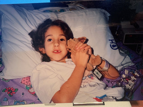 Echelon Member Melissa S. as a child in a hospital bed waiting for her first heart transplant