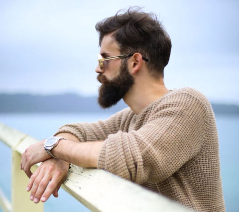 bearded man in sweater and glasses