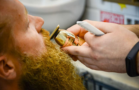 bearded man getting a trim