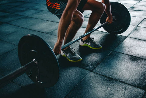 man in shorts deadlifting pose