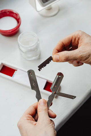 <img src="man changing straight razor.png" alt="man changing the blade on a straight razor">