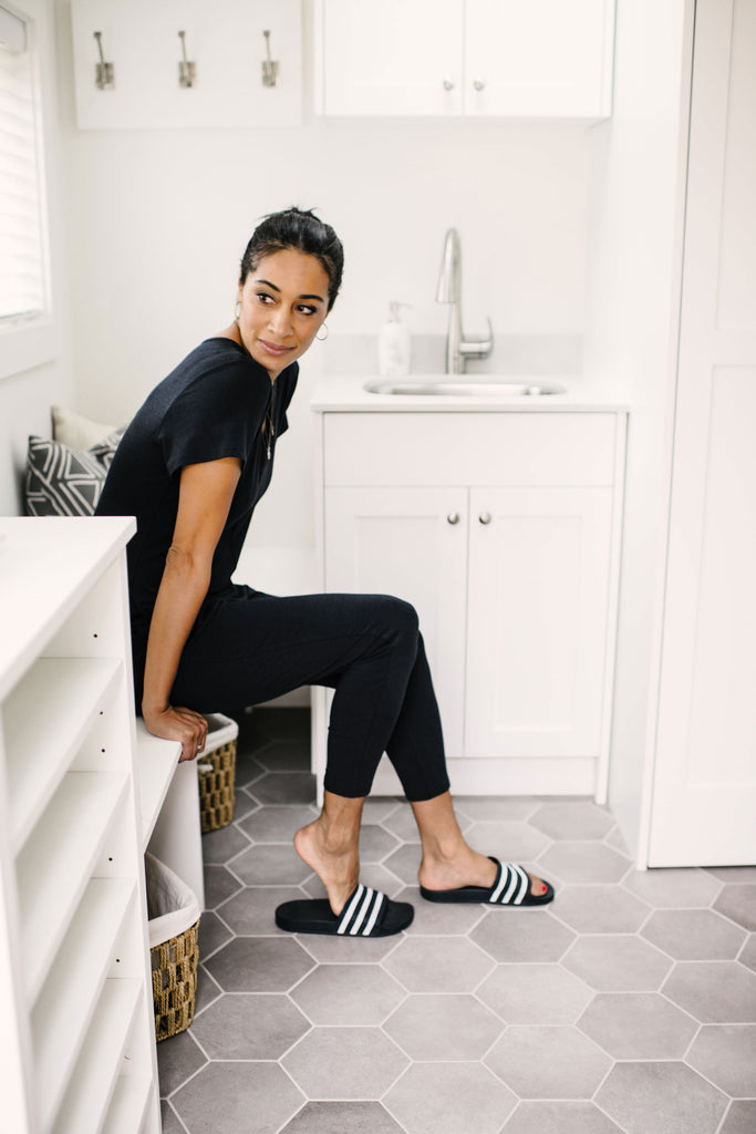 lady wearing romper in laundry room