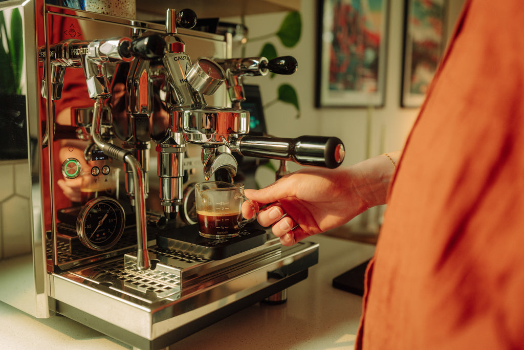 person making an espresso on the proftiec drive espresso machine lifestyle by clive coffee