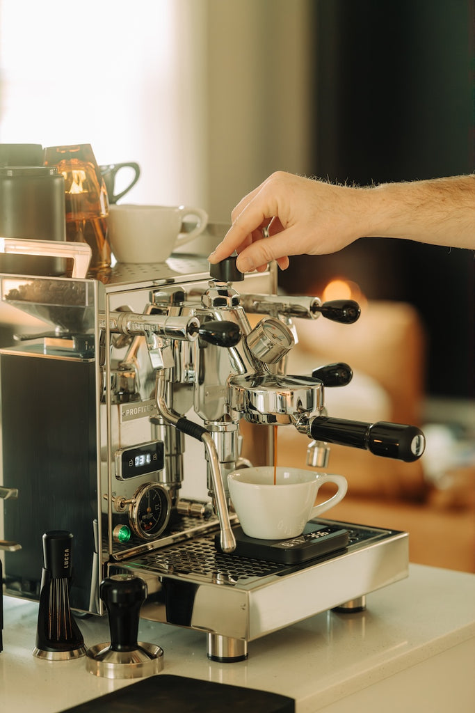 person pulling an espresso shot and using flow control lifestyle by ben matthews