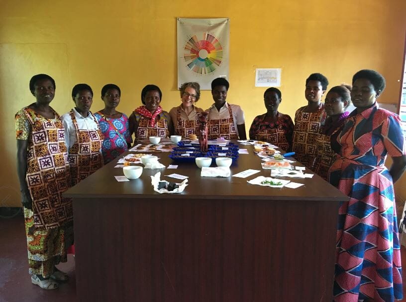 Ruth Ann Church and members of Ejo Heza during a coffee tasting. C/o Artisan Coffee Importers