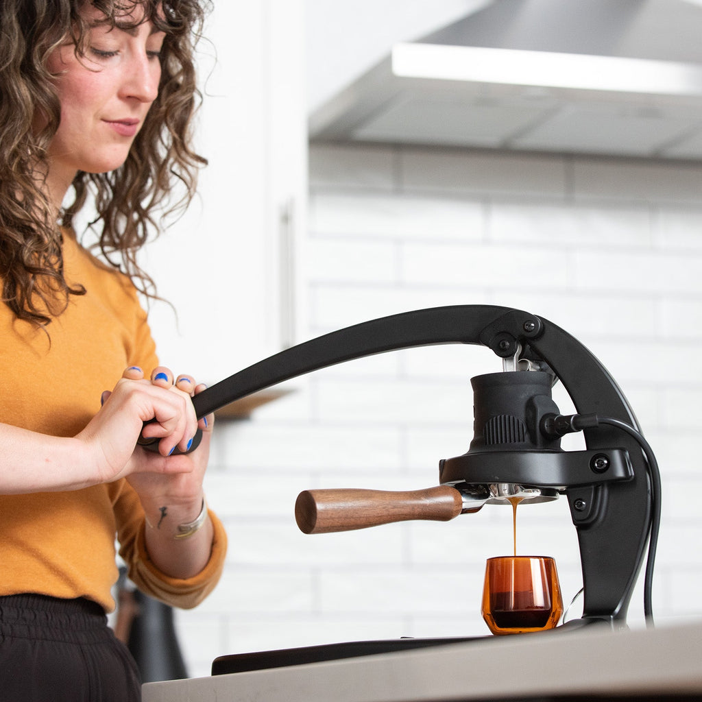 Woman pulling an espresso shot on the Flair 58plus lifestyle photo by Flair Espresso