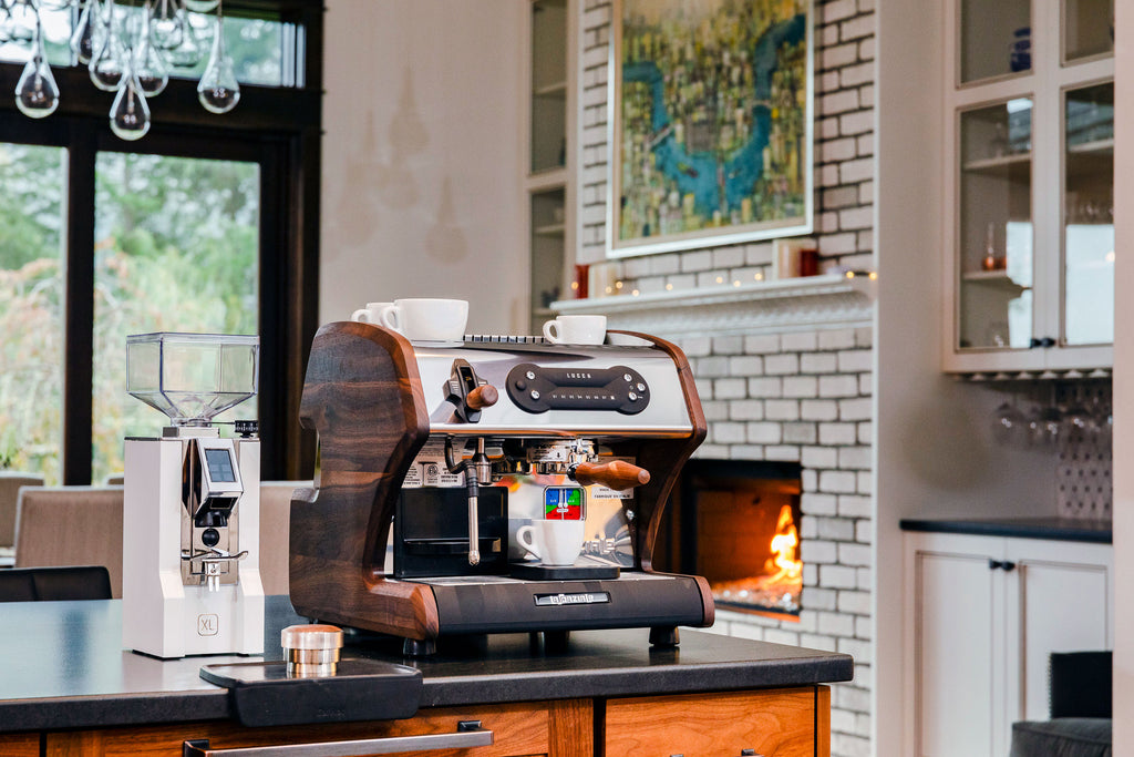 lifestyle photo of the walnut LUCCA A53 Mini espresso machine & Eureka Mignon ORO XL in white by Clive Coffee