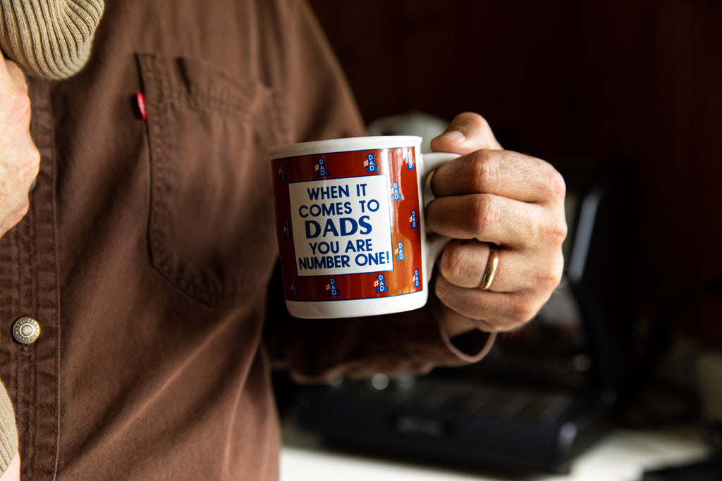 dad holding a mug that says world's best coffee dad lifestyle by clive coffee