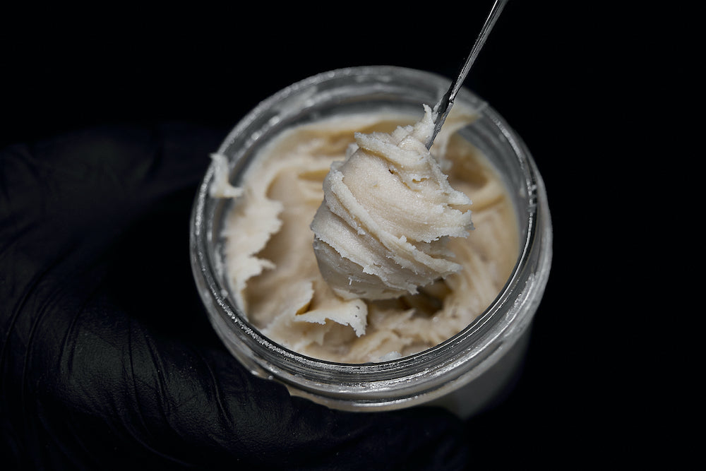 Inside of a glass jar live rosin that's thick and rich with terpenes is whipped up into badder.