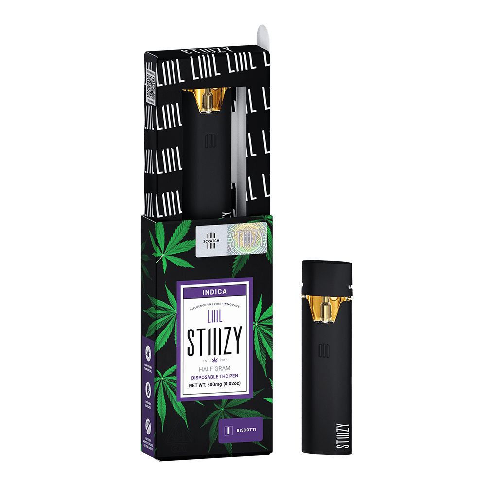 A disposable weed pen with distillate derived from the Biscotti weed strain stands next to its black blox.