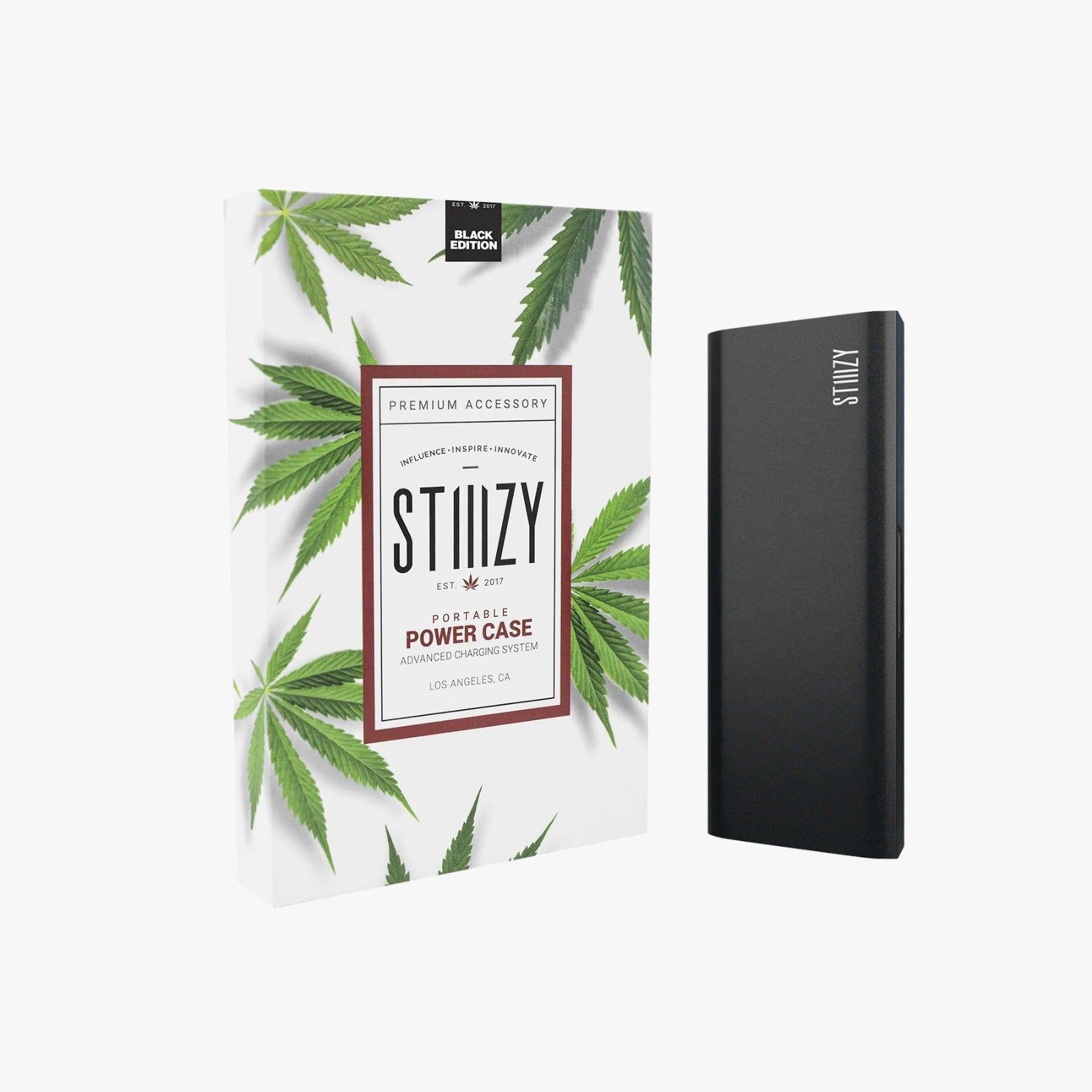 A black STIIIZY power case for charging weed pen batteries stands next to its package.