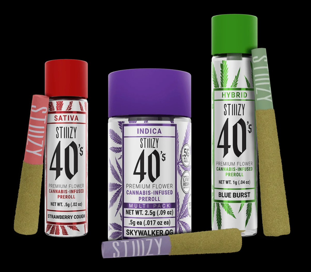 Three infused pre-rolls made with premium cannabis flower and extracts, stand or lie next to their jars with colorful caps.