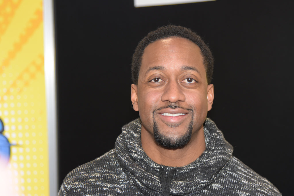 Jaleel White, another celebrity lover of cannabis flower, smiles at the camera, sporting a gray, black and white turtle neck.