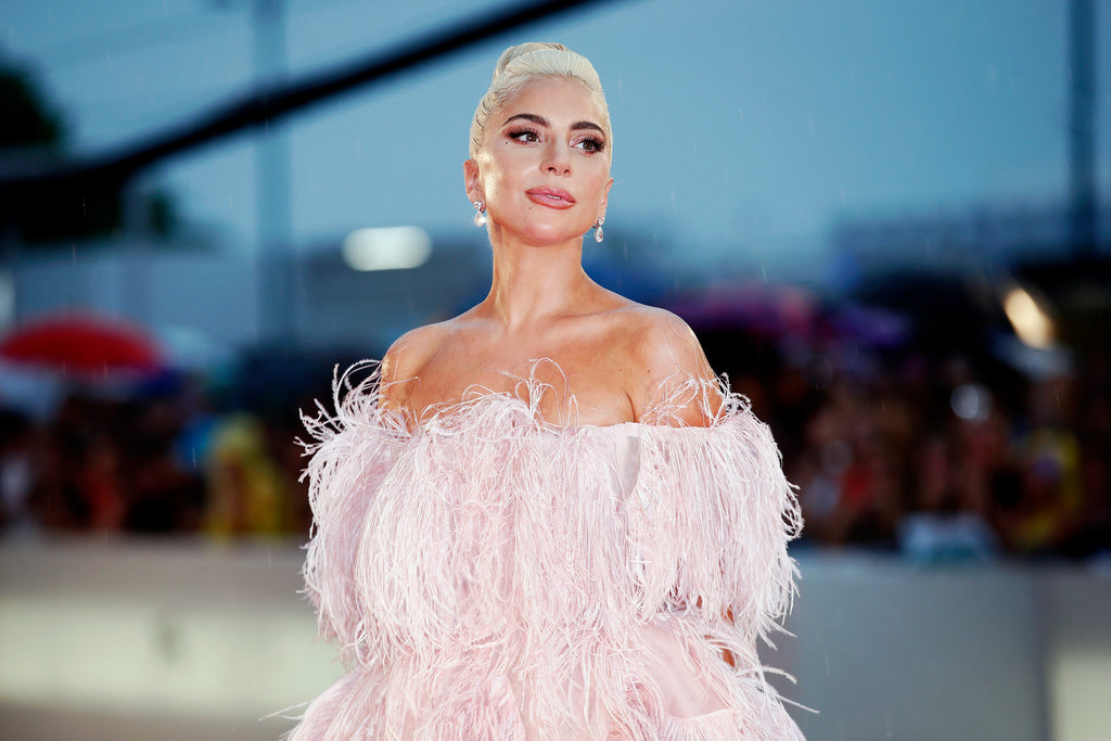 Cannabis loving celebrity Lady Gaga wears a stringy pink dress and a diamond earrings.