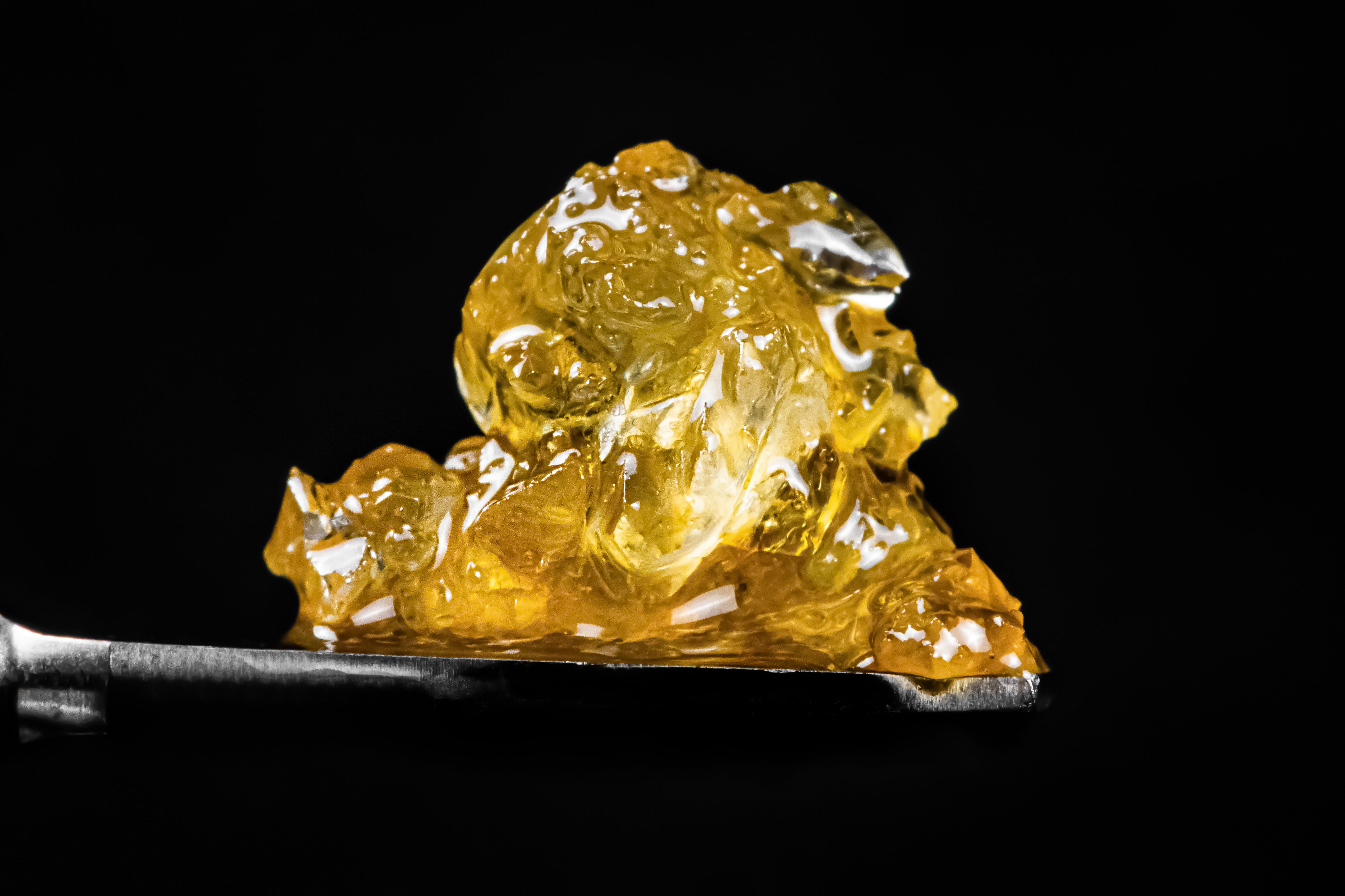 Live resin diamonds ready to be dabbed are served on a metal dabbing tool.