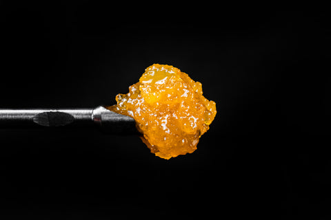 Live resin diamonds served on a dabbing tool has a rich amber color.