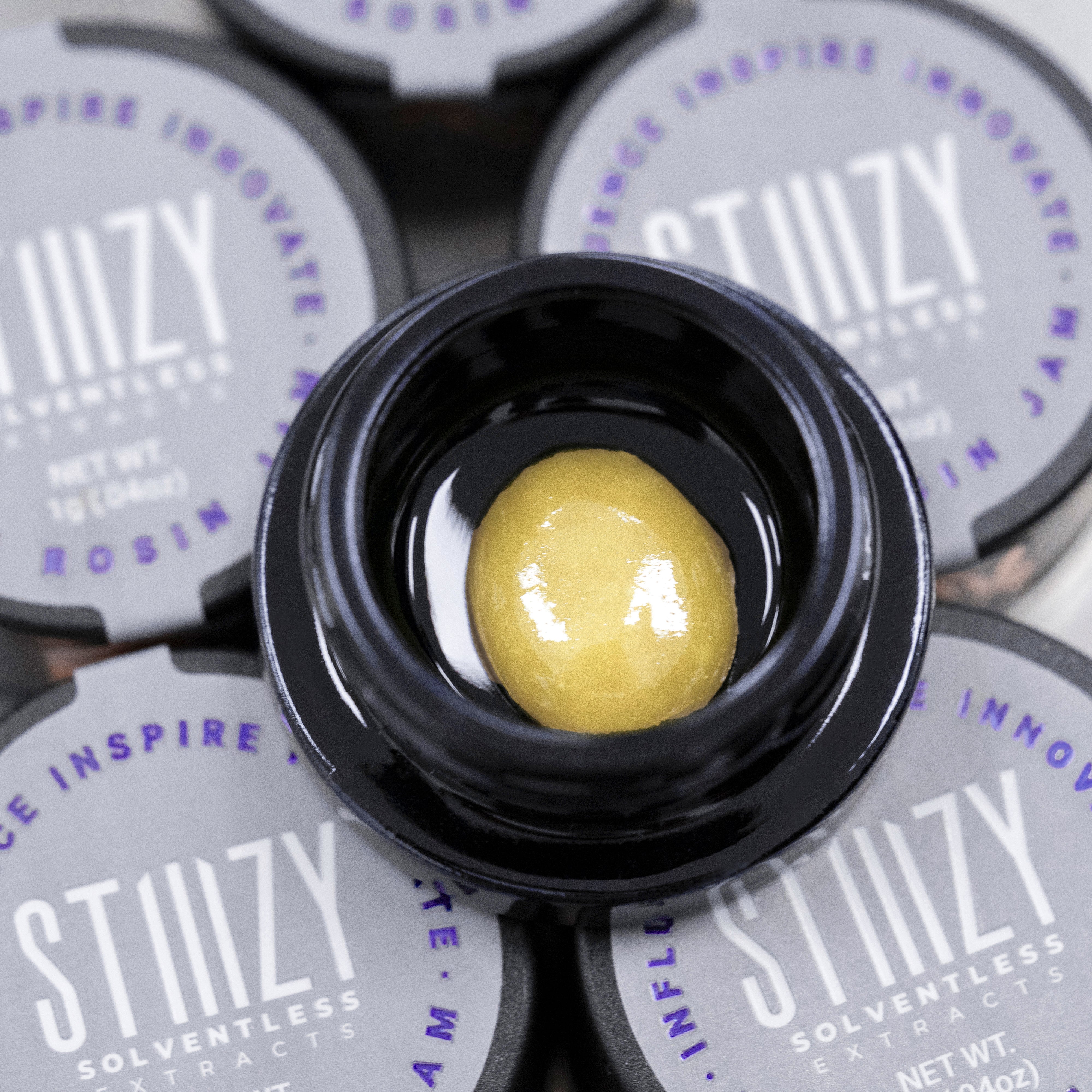 STIIIZY's solventless dab called live rosin jam sits in a black jar.