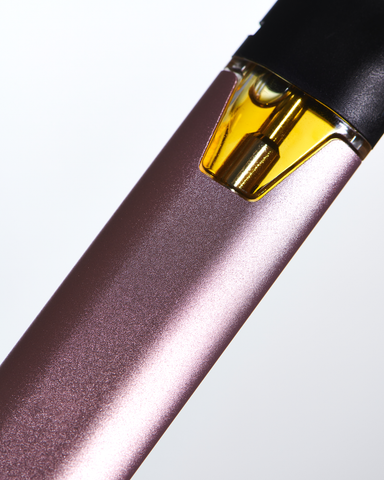 A rose-colored vape pen with a proprietary battery shows the cannabis oil in its pod.