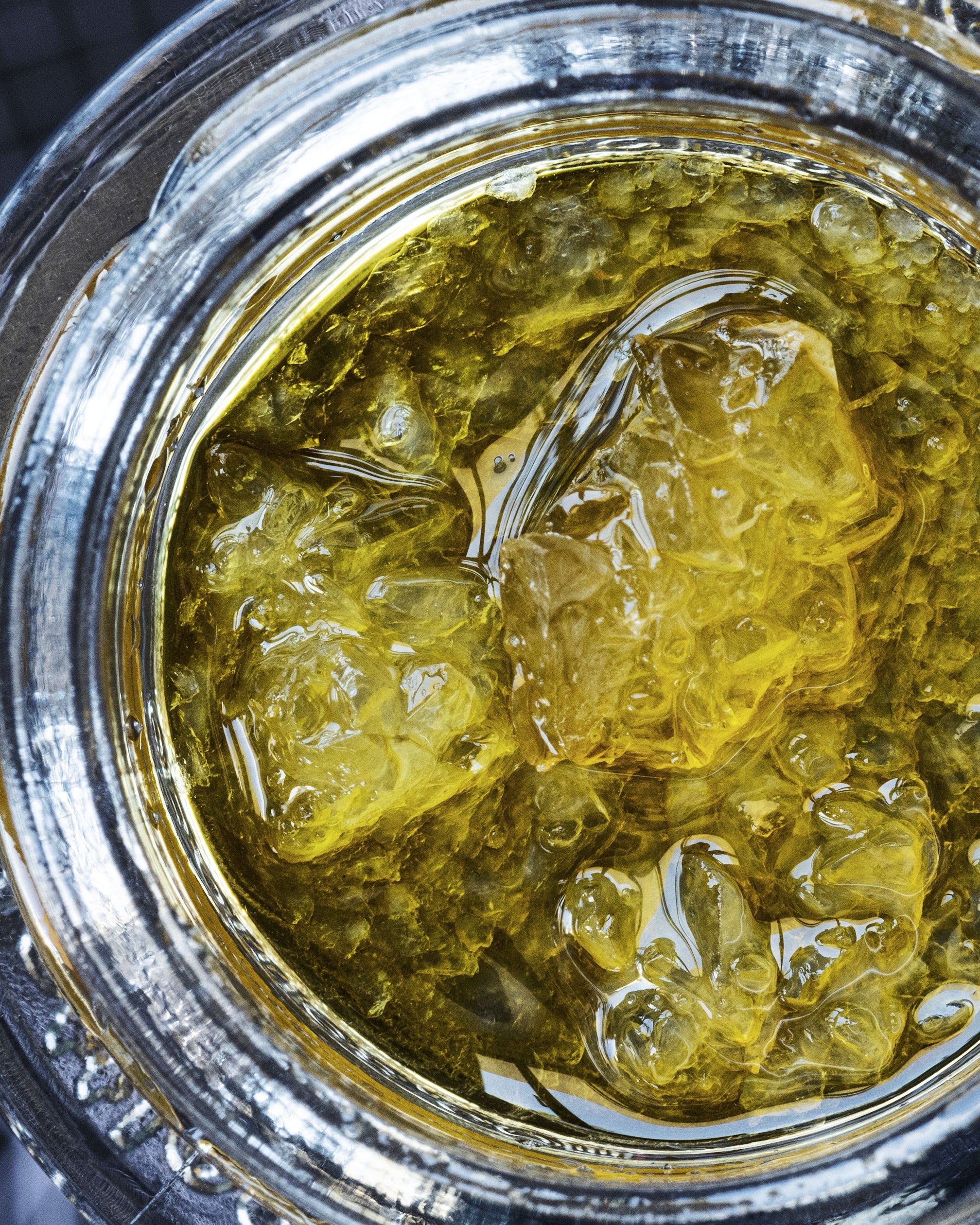 Live resin diamonds in a glass jar are cannabis concentrates ready for dabbing.