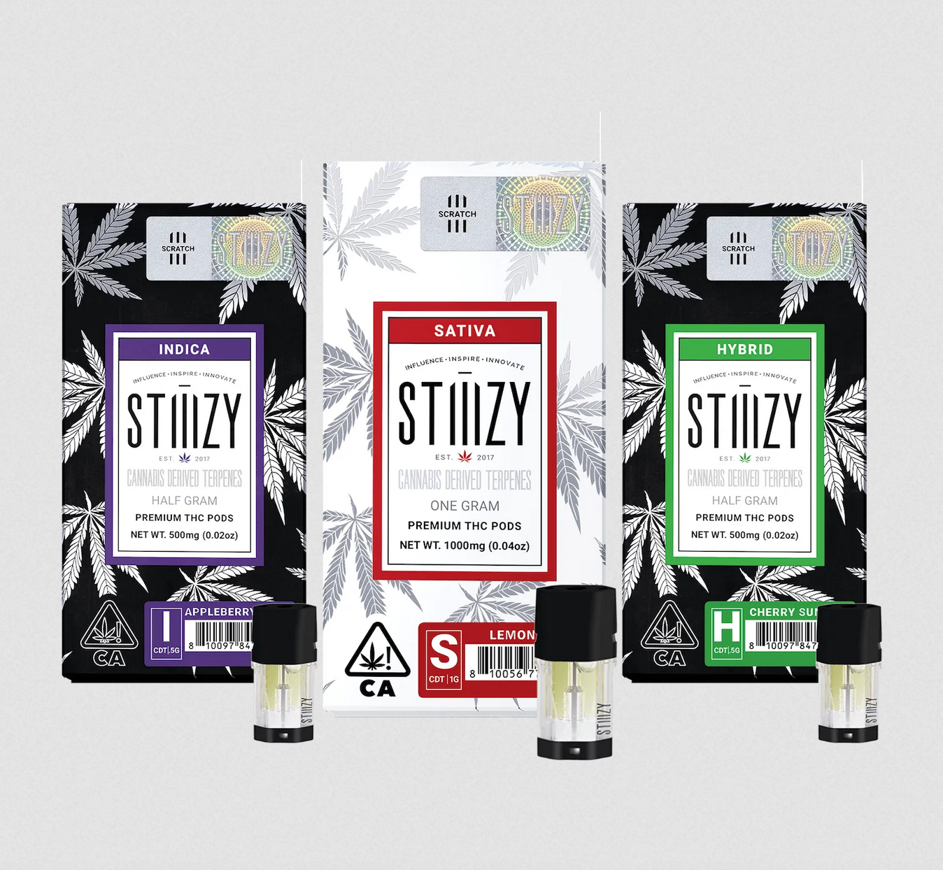 Three weed vape pods with cannabis-derived terpenes stand in front of their STIIIZY packaging.