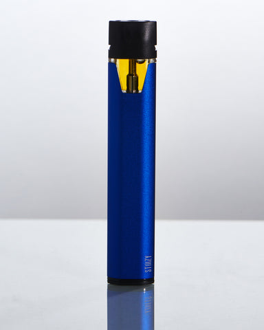 A vape pen in blue stands on a table and shows the cannabis oil in its proprietary pod system.