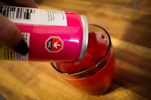 A weed edible like this cannabis-infused beverage in a red can is being poured into a cup.