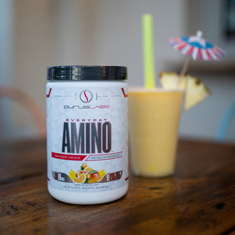 Everyday Amino next to a cocktail