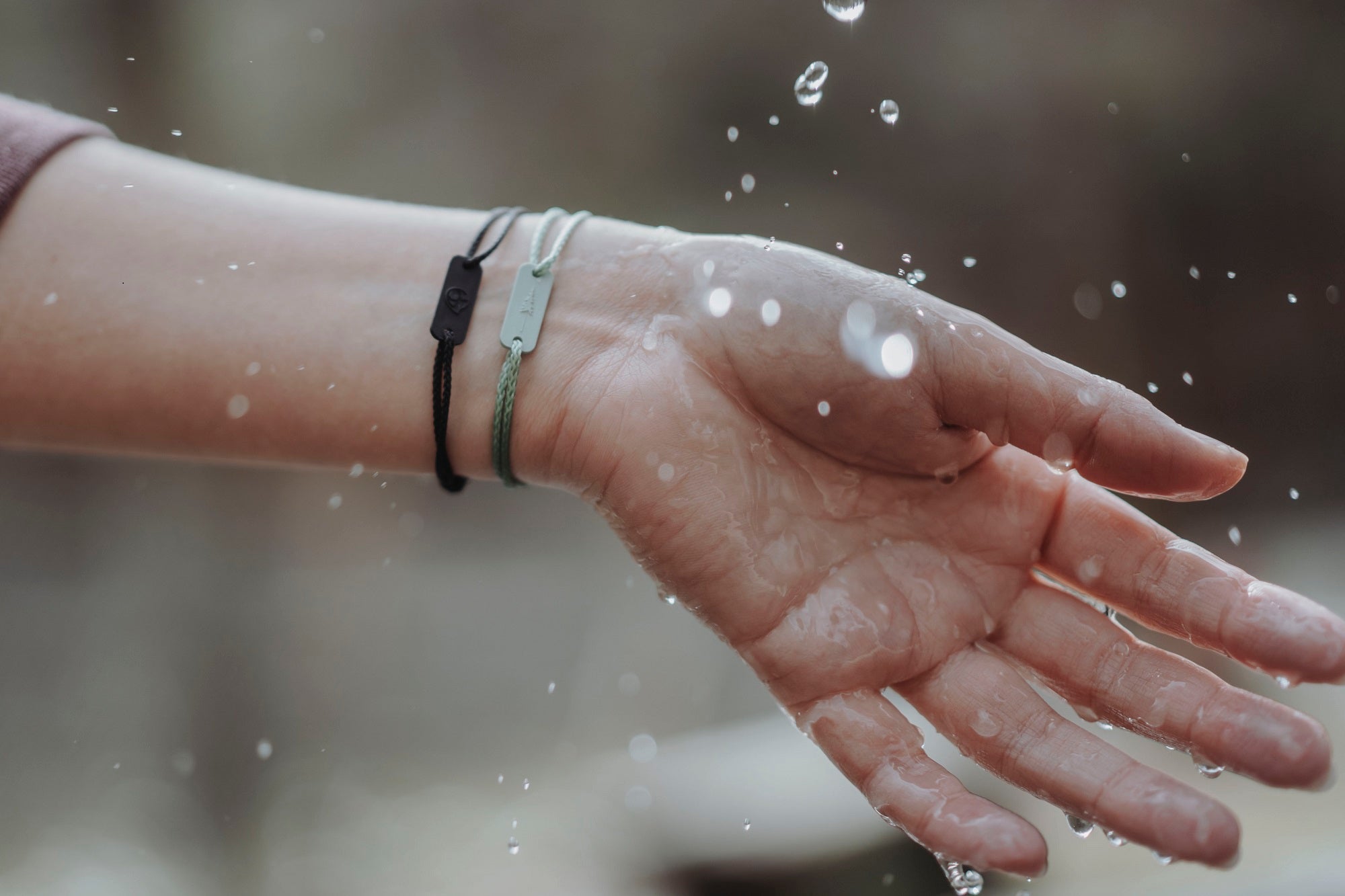 Hand with bracelet and water