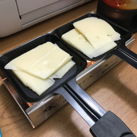Raclette Cheese in dishes to melt on the Alpine Raclette Melter