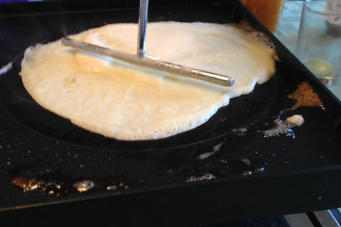 Crepe dough spread on the reversed side of the raclette grill top