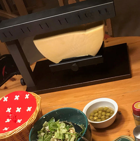 Emmi Raclette Cheese under the heating element of the Raclette Melter