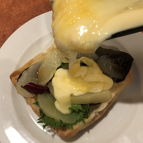 Raclette cheese is slathered onto the pear sandwich
