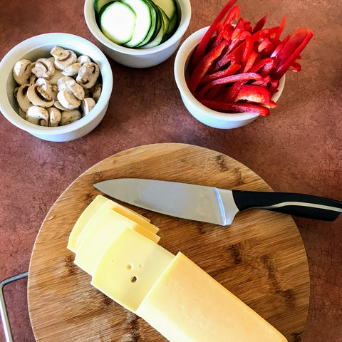 Sliced vegetables and raclette cheese