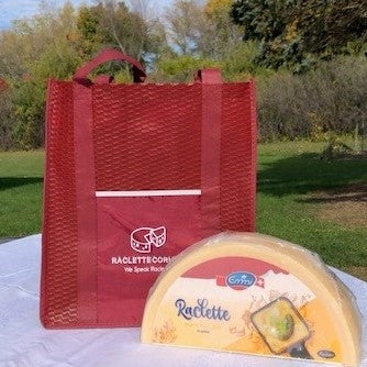 Half wheel of Raclette cheese with Grocery bag from RacletteCorner