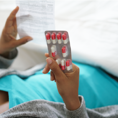 A hand holding pills