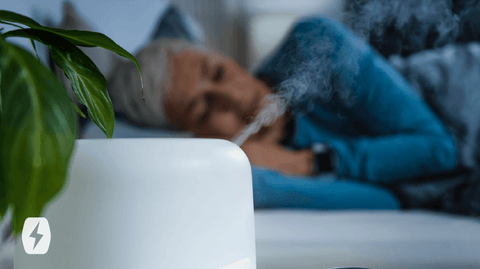 Woman lying down next to a humidifier