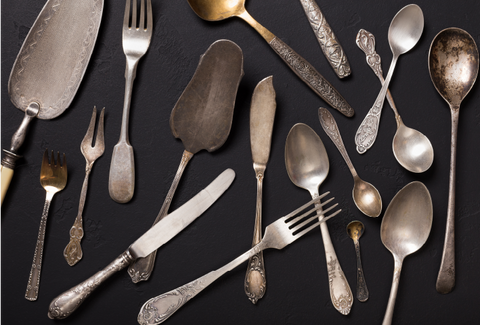 An array of tarnished utensils