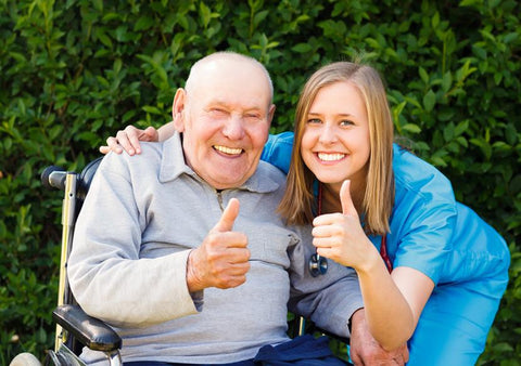 A nurse does a thumbs up with a patient