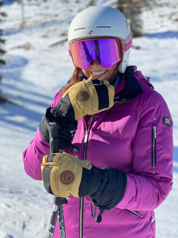 girl in a pink jacket wearing a baist mitten