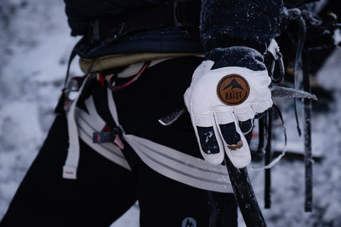 Close-up of a hand wearing a high-performance Baist ski glove, showcasing durable materials and ergonomic design for optimal comfort and protection in cold weather.