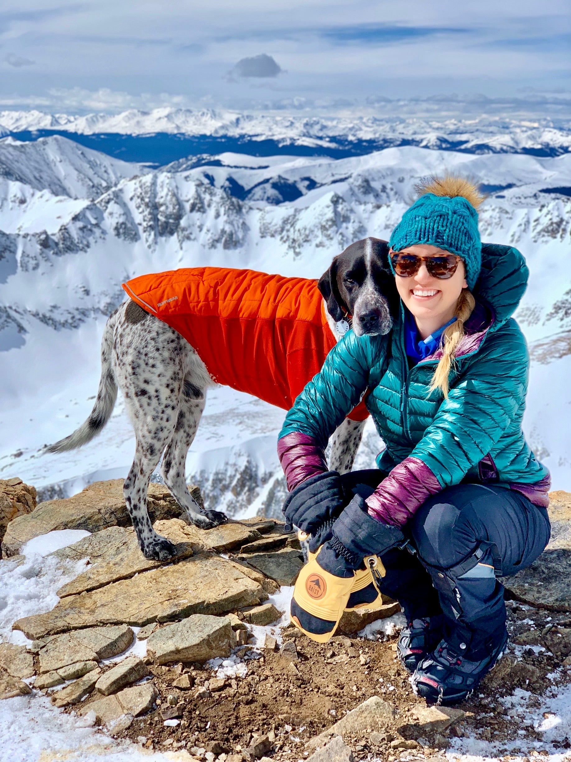 Girl with a dog on the hill wearing a glove