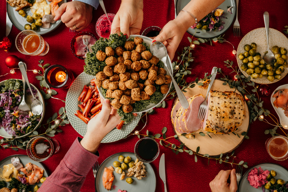 Typical swedish scandinavian christmas smörgåsbord with breaded ham, meatballs, sausauge,noisette, pickled herring and side dishes Julbord med griljerad skinka sill och lax