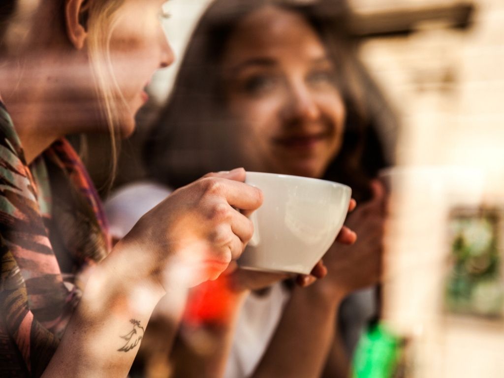 Friends relaxing with coffee at cafe in Scandinavia