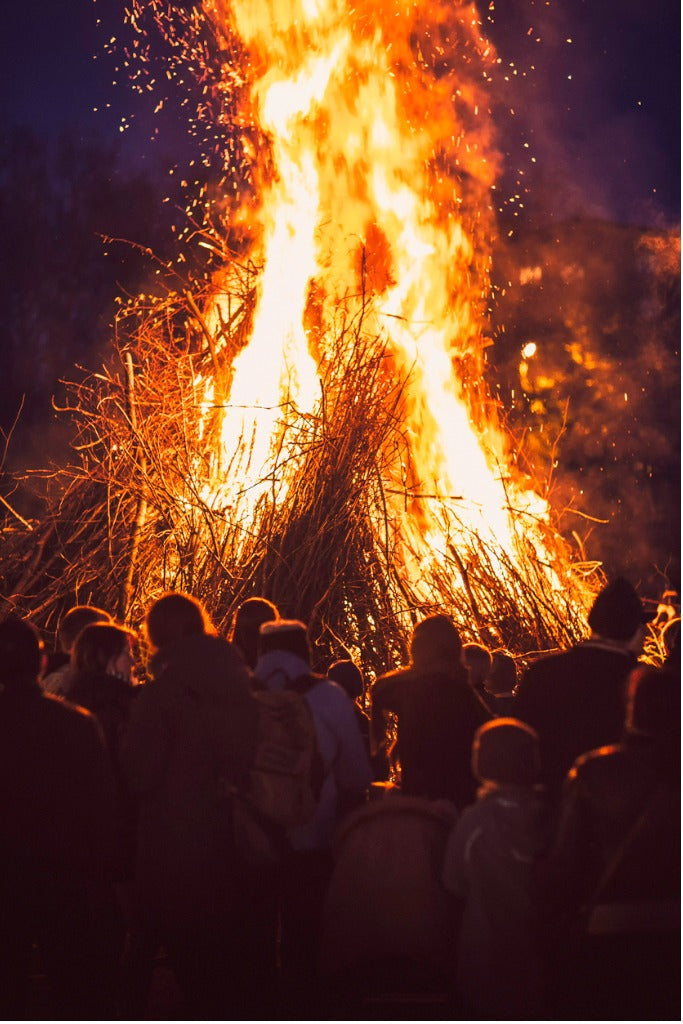 People gathered around a large bonfire