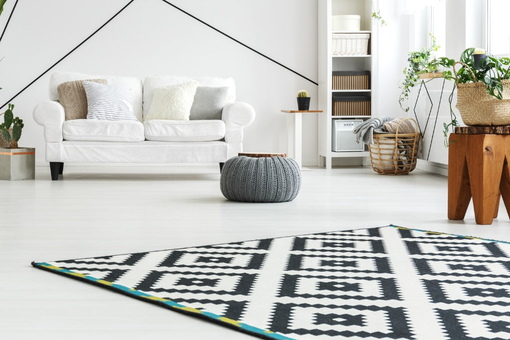 Scandinavian style living room with geometrical pattern rug