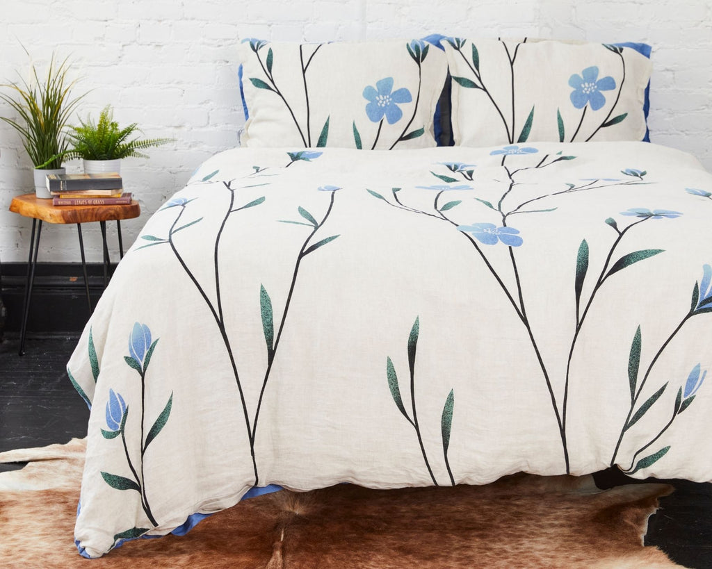 Organic linen duvet cover set with blue flax flowers on gray background