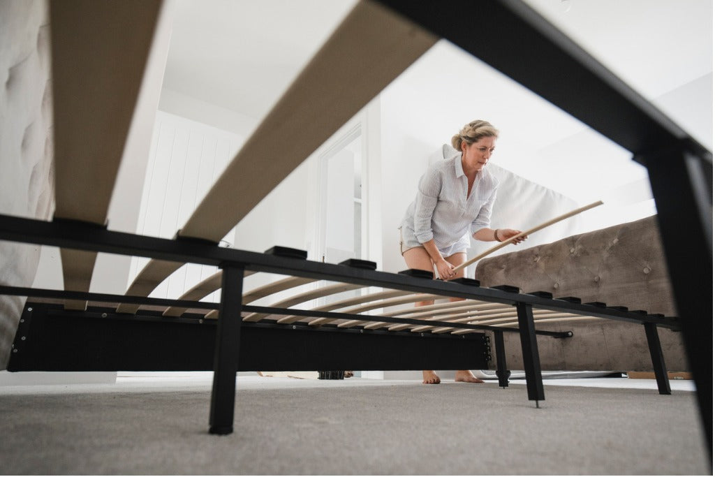 Woman Building Bed in New Home