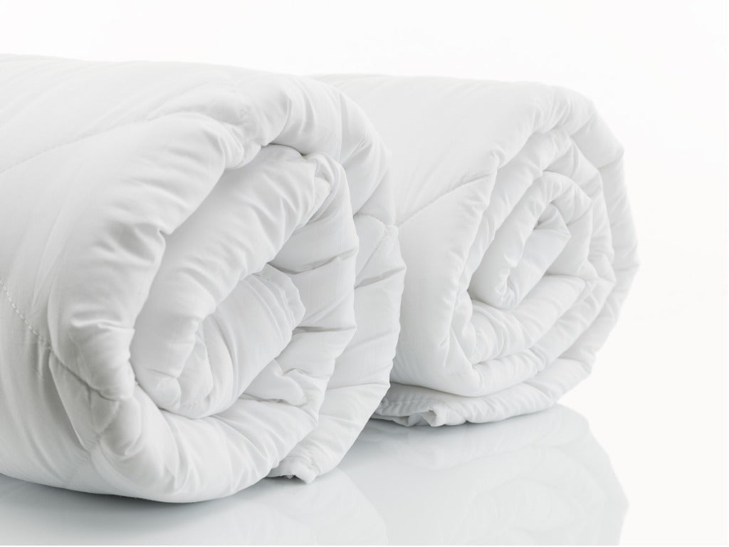 Two white duvet inserts on a white background