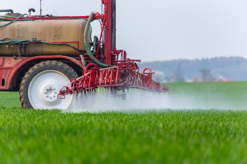 Field being sprayed with chemicals