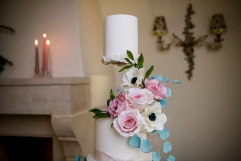 floral white wedding cake with floating cake tier 